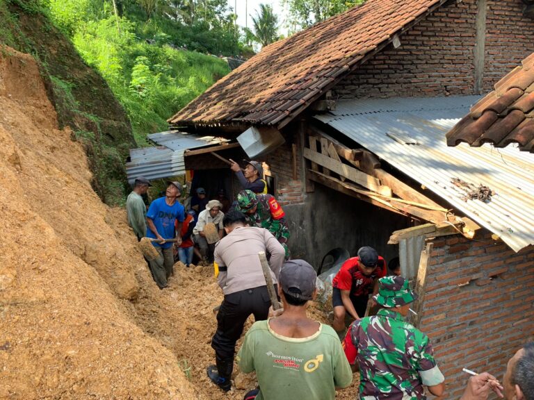 Sinergitas Polisi Bersama TNI Bersihkan Tanah Longsor yang Timpa Rumah Warga di Trenggalek